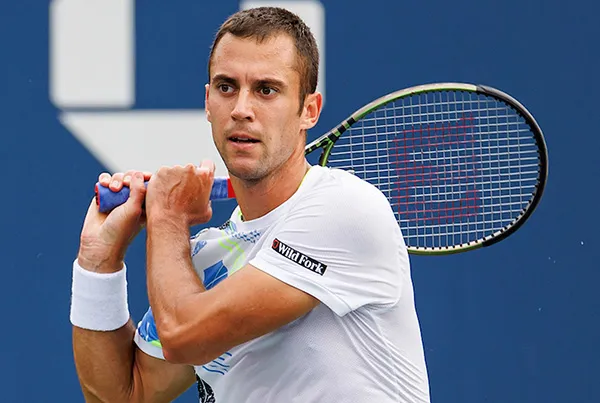 Tennis player with sleeve sponsor patch